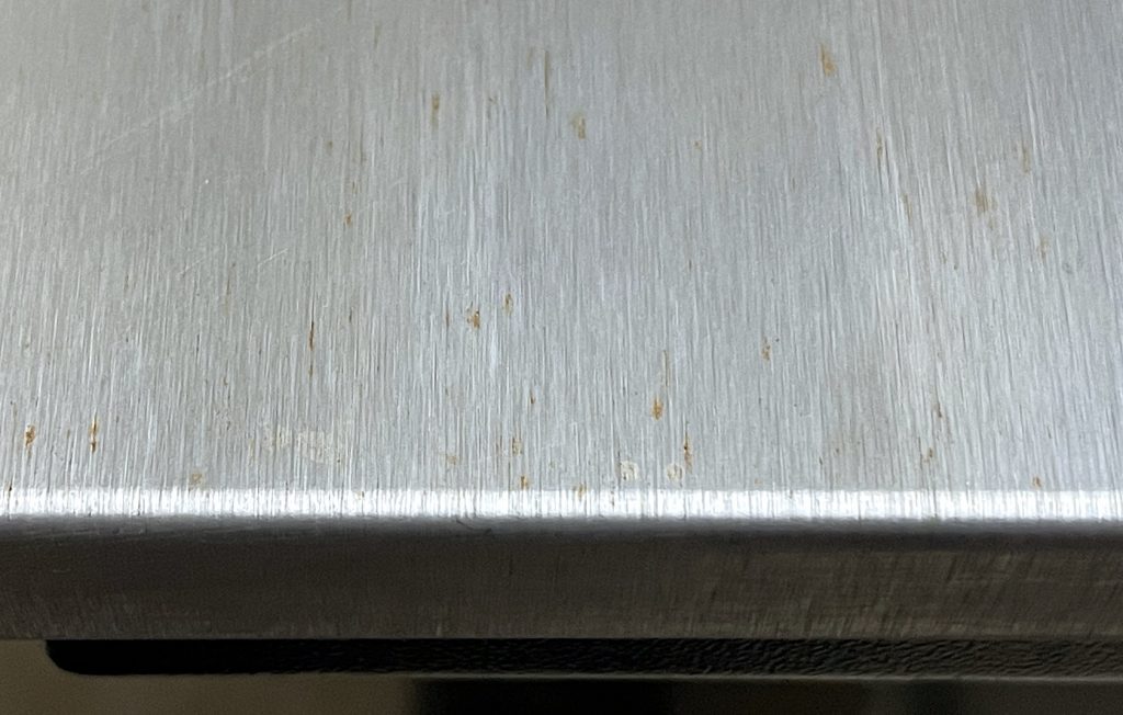 Brushed stainless steel with rust stains