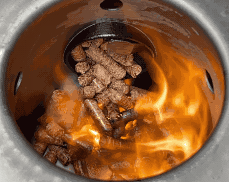 Wood pellets burning in Z grills pellet smoker fire-pot